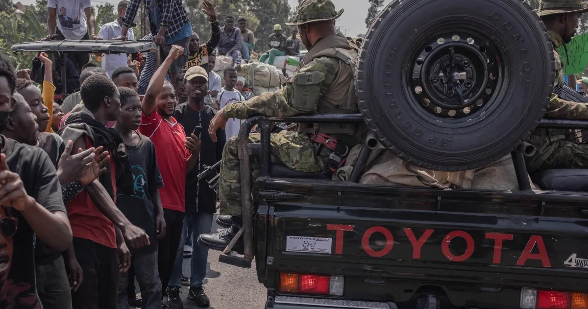 "Image depicting a tense scene in Kinshasa, DR Congo, where armed men in military uniforms clash with guards at the residence of a top politician, leading to casualties and heightened security concerns."