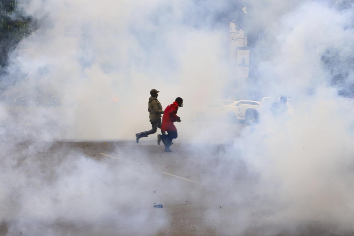A tense protest scene in Kenya with individuals holding placards, amidst rising fears of enforced disappearances. The growing number of activists, journalists, and citizens vanishing under mysterious circumstances has created an atmosphere of fear, suppressing political dissent in the country.