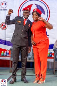 In the image, President Robert Kyagulanyi Ssentamu stands confidently beside Brenda Nakato, a prominent leader in the NUP Canada chapter. Both are dressed in their NUP attire, with Brenda in a striking red outfit and President Kyagulanyi in his official black suit. They stand united, each raising a fist—a symbol of their shared commitment to the struggle for freedom and democracy in Uganda. This powerful image highlights the solidarity between NUP's leadership in Uganda and its supporters in the diaspora, showcasing their collective resolve to bring about meaningful change in their homeland.