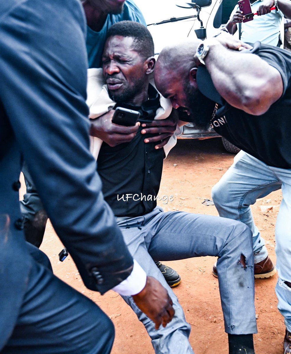 Breaking News: Bobi Wine Reportedly Shot by Police Officer in Uganda" with an image of Robert Kyagulanyi, also known as Bobi Wine, being supported by his followers as he is led into a vehicle. The incident took place near Kampala, and the article details the alleged involvement of a police officer, Afande Mwesigye, in the shooting. The event has caused widespread outrage, particularly within the opposition party, National Unity Platform.
